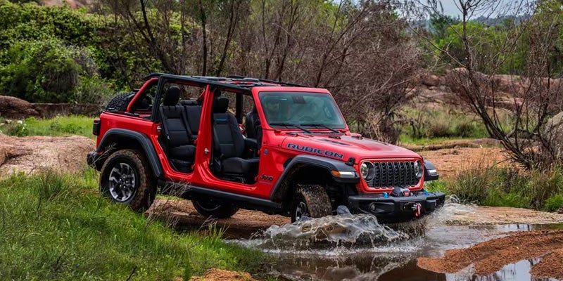 Red Jeep Wrangler water crossing