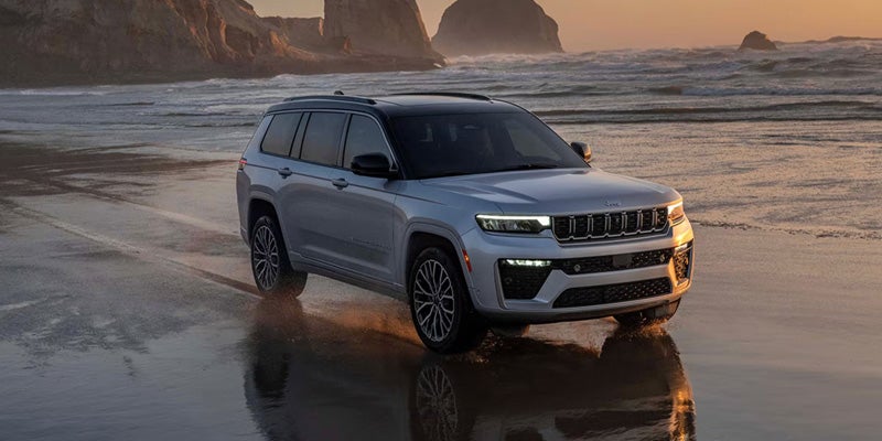 White Jeep Grand Cherokee on beach