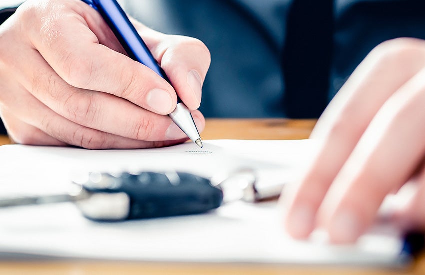 Customer signing auto financing paperwork