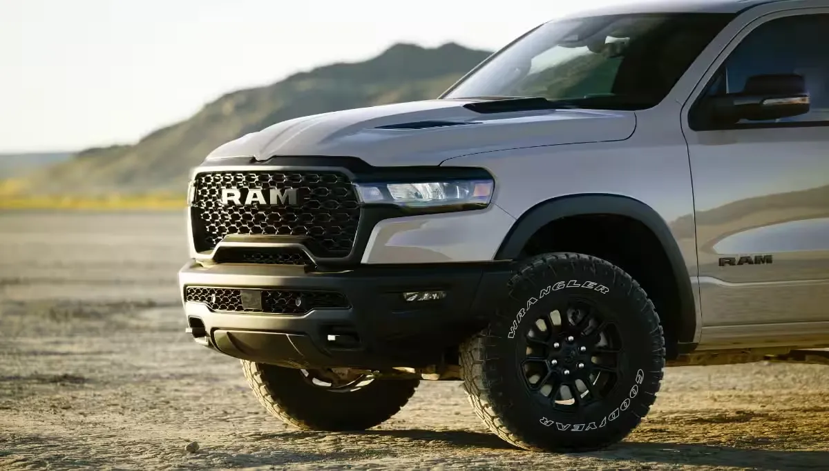 The all-new 2025 RAM 1500 off-roading near someone on a dirt bike